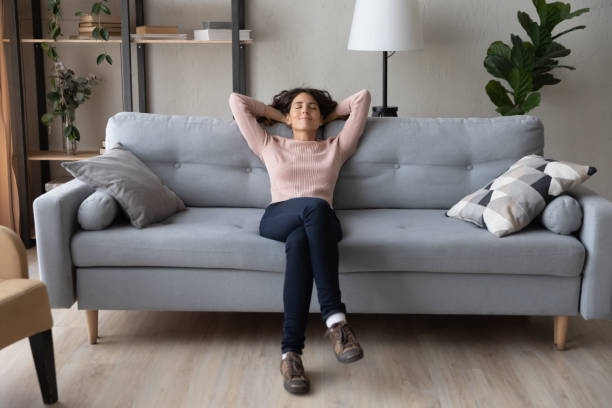 istock Tranquil millennial pretty woman relaxing on comfortable sofa. 1222788451