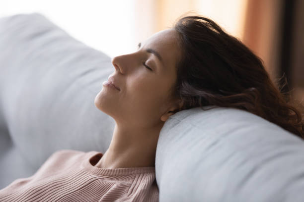 istock Tranquil peaceful young woman sleeping on sofa. 1222788452