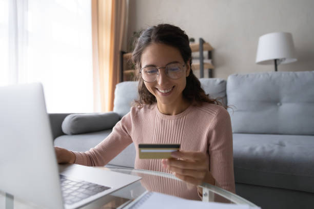 istock Smiling young woman shopping securely online on computer. 1222788492