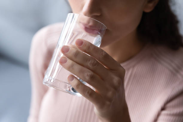istock Close up focus millennial female drinking pure water. 1222788548