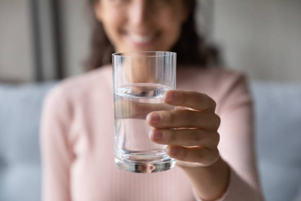 istock Smiling lady recommending drinking pure aqua every day. 1222788597
