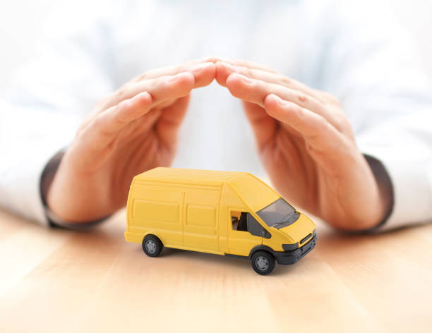 istock Transport yellow van car protected by hands 1222789220