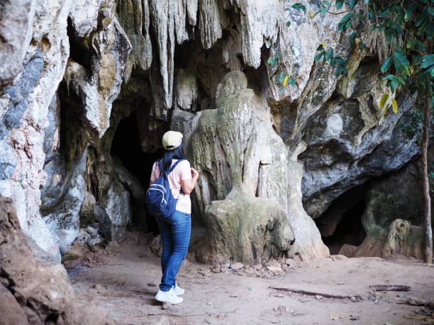 istock woman tourist walking into the cave 1222790169