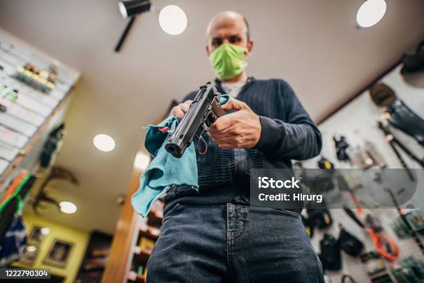 One Mature Man Disinfecting His Shop Before Opening Stock Photo - Download Image Now