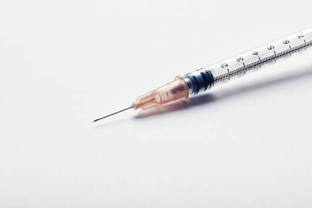 empty syringe on green table