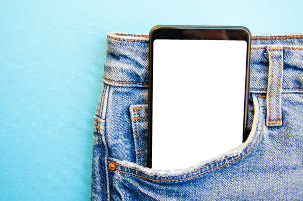 istock White screen smartphone in jeans pocket. Smartphone place for text. Smartphone in a pocket on a blue background.  Copy Space 1222791990