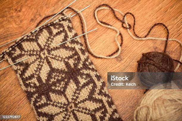 Knitting Lying On Wooden Background With Needles And Sewing Clew Stock Photo - Download Image Now