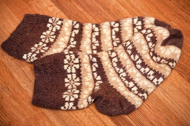 istock pair of knitted woolen socks lying on the floor 1222792879