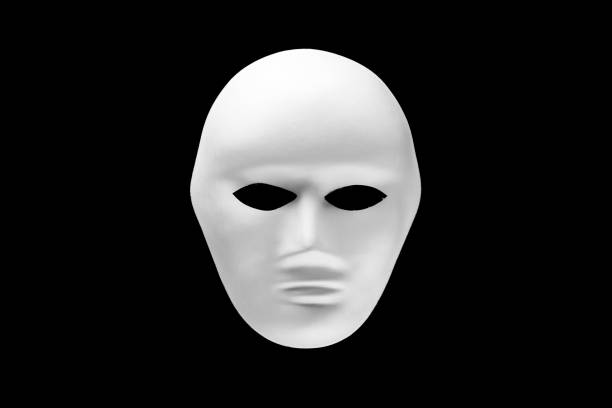 istock White human face mask isolated on black background 1222795429