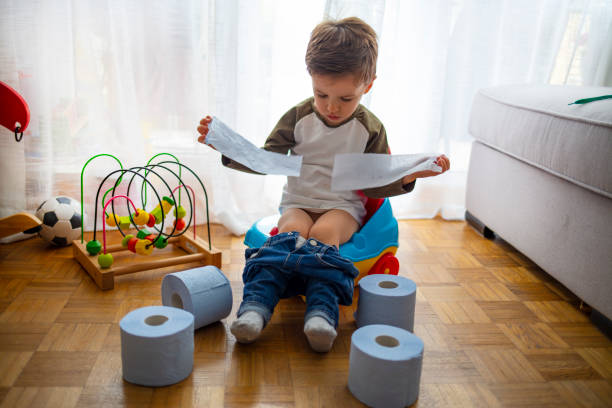 istock Toddler sitting on his potty as he starts his potty training. 1222797669