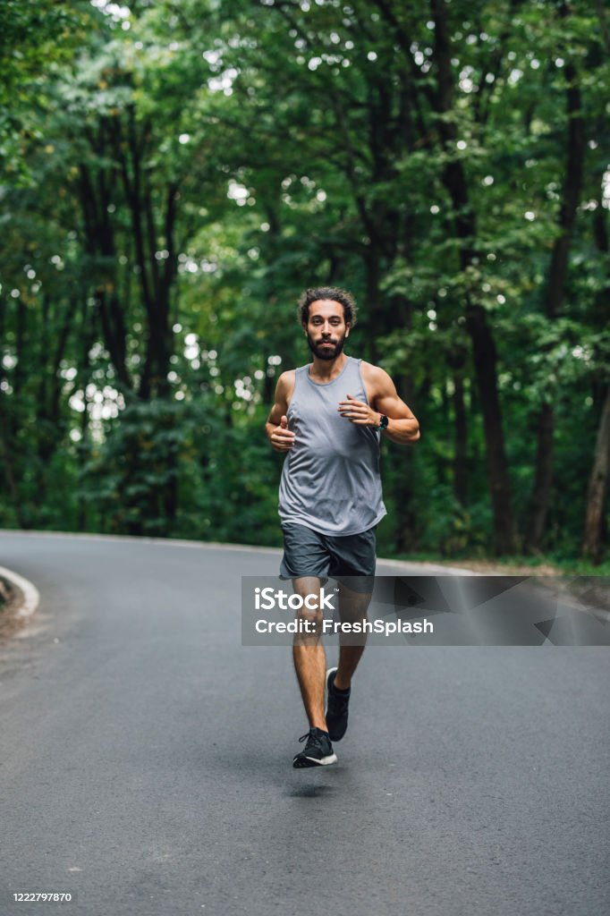 Running Single Man Flattening The Curve Man Running Alone In Nature Looking At Camera ...