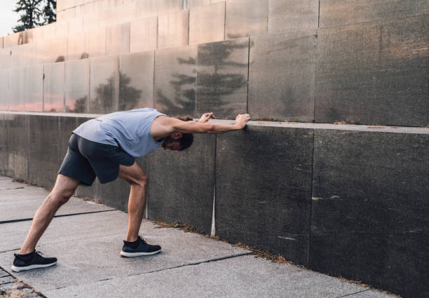 istock Tired Man Runner Stretching after the Outdoor Workout 1222797888