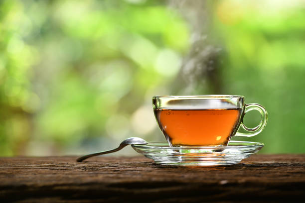 istock Morning cup of tea with smoke on nature background 1222800266