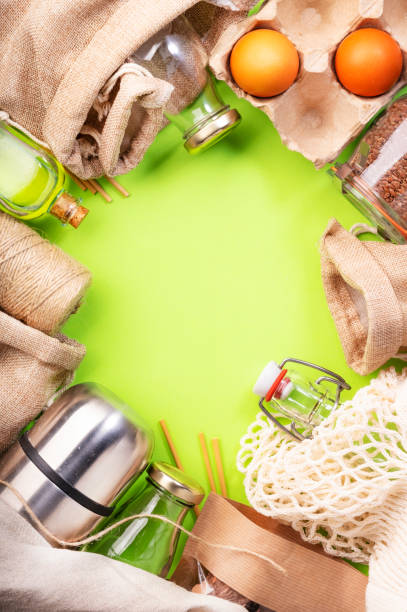 istock Zero waste, plastic free and sustainable lifestyle concept. Recyclable, reusable eco friendly bags, package, bottles, cans and storage containers, mesh bag. Green background, copy space, top view 1222800339