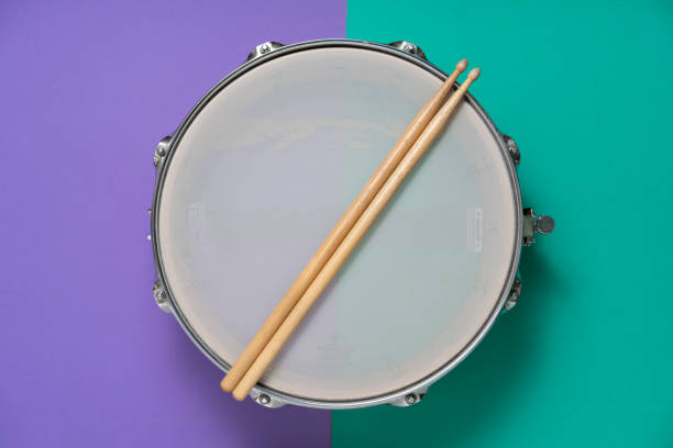istock Drum stick and drum on table background, top view, music concept 1222801419