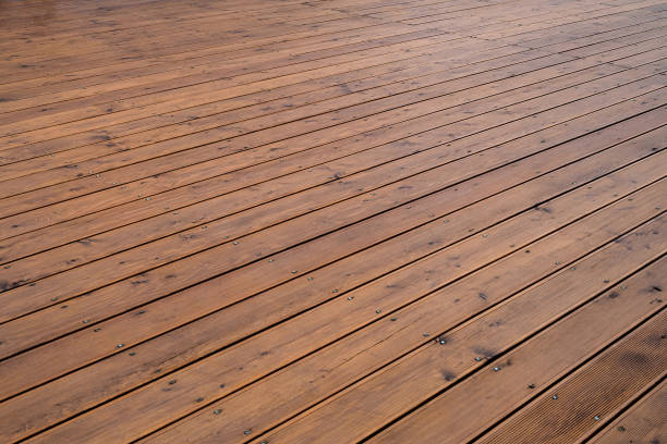 Natural outdoors wooden board floor. Brown floor large area. Horizontal layout perspective. stock photo