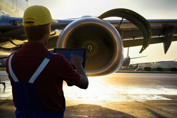 istock Young male engineer using digital tablet for airplane mechanics at sunset 1222802443