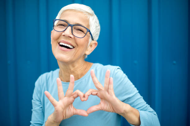 istock Happy senior woman against blue background. 1222803025