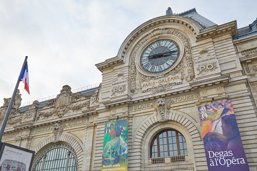 Paris, France - November 8, 2019: Gare D'Orsay or Orsay museum building facade with clock in a cloudy day in Paris