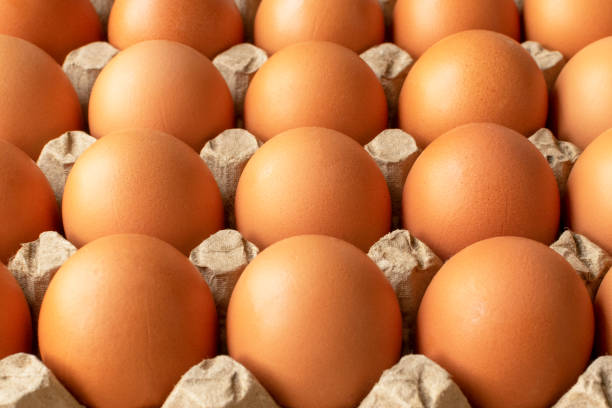istock Brown egg in paper packaging. Container for eggs. Recycling. Healthy rustic breakfast 1222804820