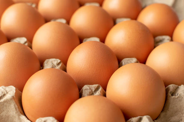 istock Brown egg in paper packaging. Container for eggs. Recycling. Healthy rustic breakfast 1222804823