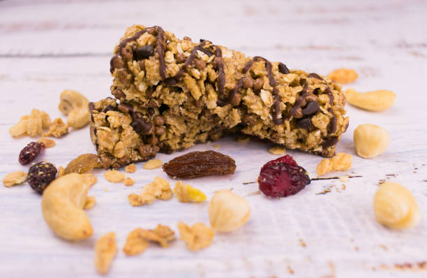 istock Useful granola bars with chocolate and nuts on the table. Close-up. 1222806023