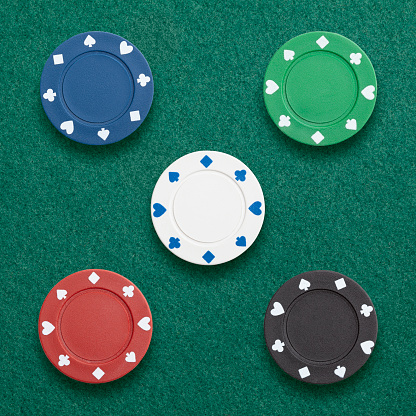 Poker chips photographed  on green cloth