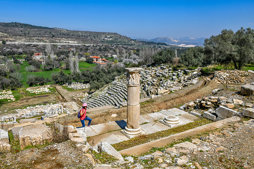 View of Acropolis hill with Propylaea and Parthenon and theater of Odeon below it in Athens, Greece from the hill of Philoppapos or Muses in summer daylight with great clouds in blue sky. Great fresh foliage of olives and cedar trees. Wide shot