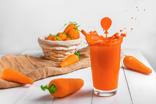 Creative. carrot juice. splashes in shape of balloon. bright summer photography