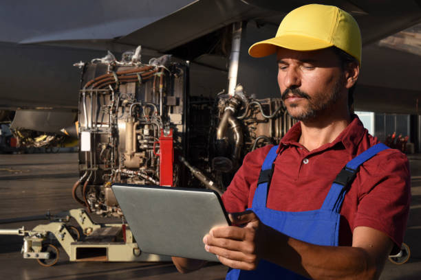 istock Young male engineer using digital tablet for airplane mechanics 1222808869