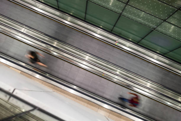 Long exposure of a people mover Kuala Lumpur, Malaysia: Long exposure of a walkalator or treadmill directly from above. airport travelator stock pictures, royalty-free photos & images