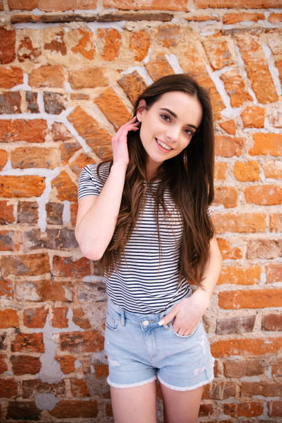 beautiful smiling brunette looking at the camera. - stripped shirt imagens e fotografias de stock