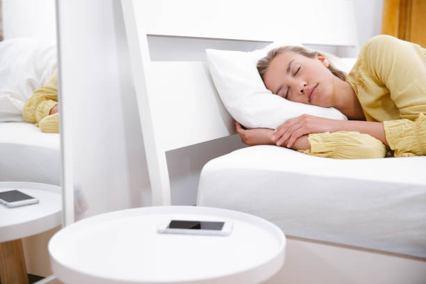 istock Young woman sleeping on her bed in the morning. 1222810699