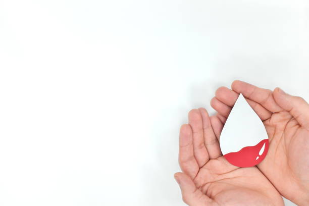 blood transfusion and world blood donor day concept. hands holding blood drop. white background. - anemia imagens e fotografias de stock