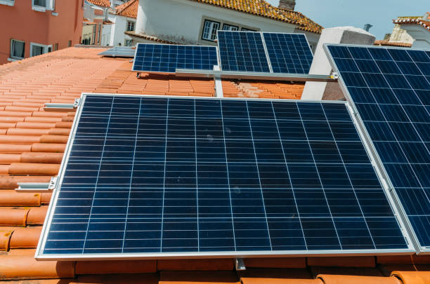 istock Solar panel on a red roof reflecting the sun and the cloudless blue sky 1222813073