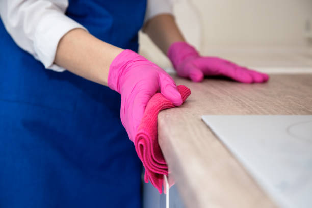 istock Girl in pink rubber gloves washes the kitchen. 1222813213