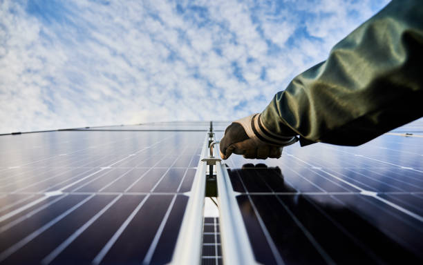 istock Male technician mounting blue photovoltaic solar panel. 1222813564
