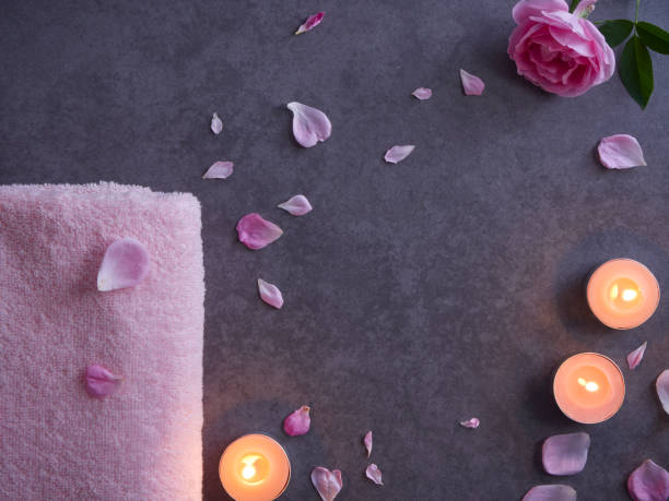 istock Spa composition of pink rose and candles on grey background 1222813926