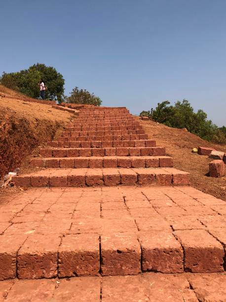 Path to Chapora fort Goa Brick path to Chapora Fort in Goa on a hill top. chapora fort stock pictures, royalty-free photos & images