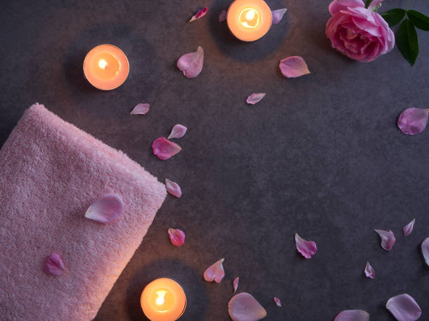 istock Spa composition of pink rose and candles on grey background 1222813967