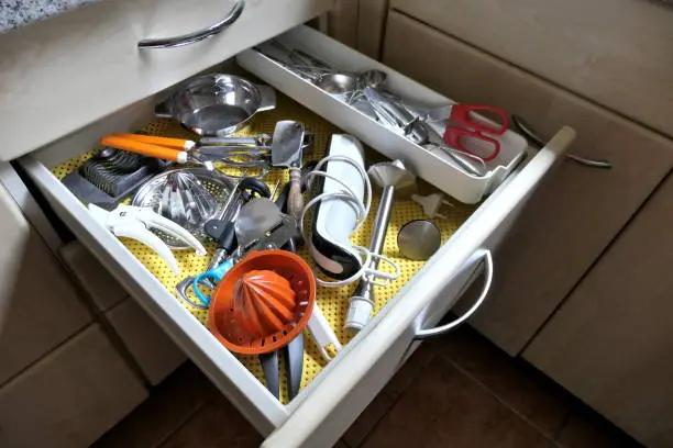 Kitchen utensils in an open drawer