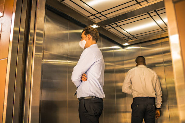 istock Social Distancing on Elevator with passenger stand in the corner 1222815022