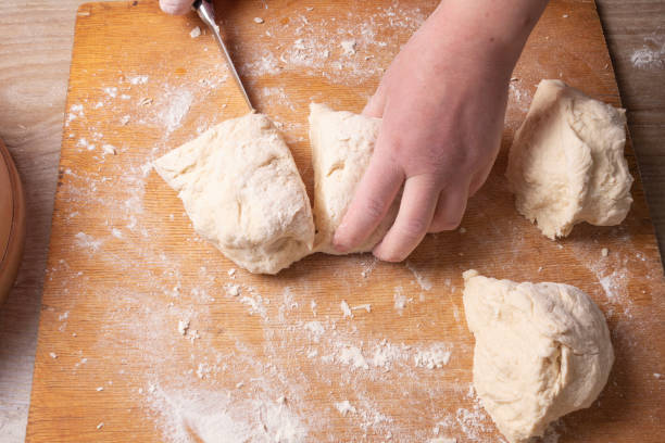 istock Female hands mixing dough in the home kitchen. 1222815197