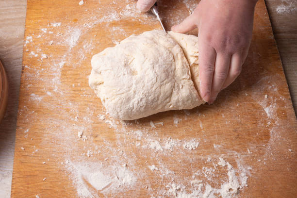 istock Female hands mixing dough in the home kitchen. 1222815205