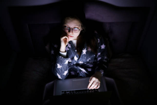 istock Young Woman Thinking On Her Laptop Computer in The Evening 1222817434