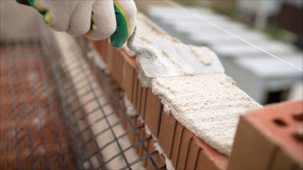 istock Bricklaying isolated on white. Brickwork, brick house construction 1222817478