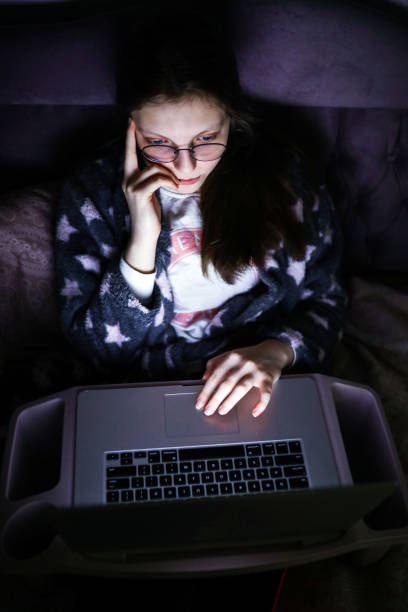 istock Young Woman Thinking On Her Laptop Computer in The Evening 1222818216