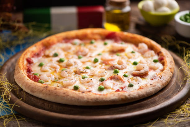 istock Pizza, cheese, peas and shrimps on a wooden table 1222818535