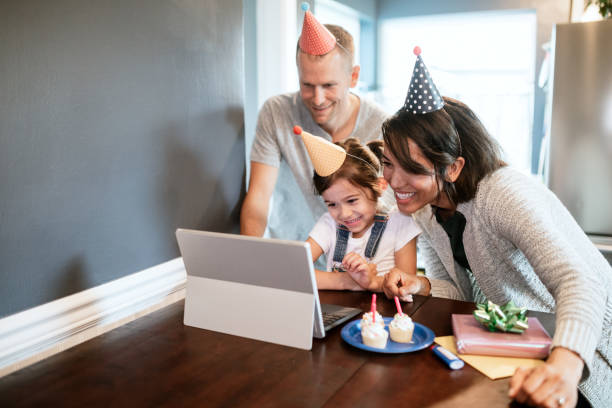 Cute Family Celebrates Virtual Birthday Party Online A social distanced birthday party hosted on a digital platform allows friends and family to join in with a little girl for her special day. virtual birthday celebration stock pictures, royalty-free photos & images