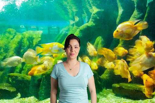 portrait of woman  with virtual background aquarium with yellow fish